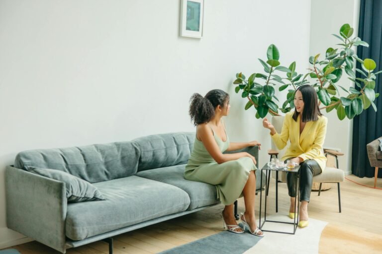 Women Sitting on Gray Couch